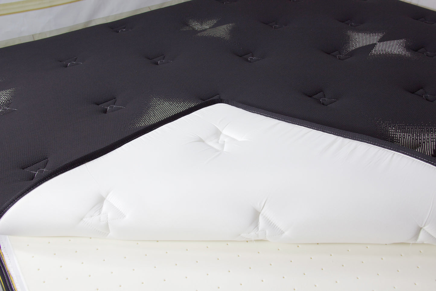 Black mattress encasement made from premium cotton with a zippered closure for full mattress protection.