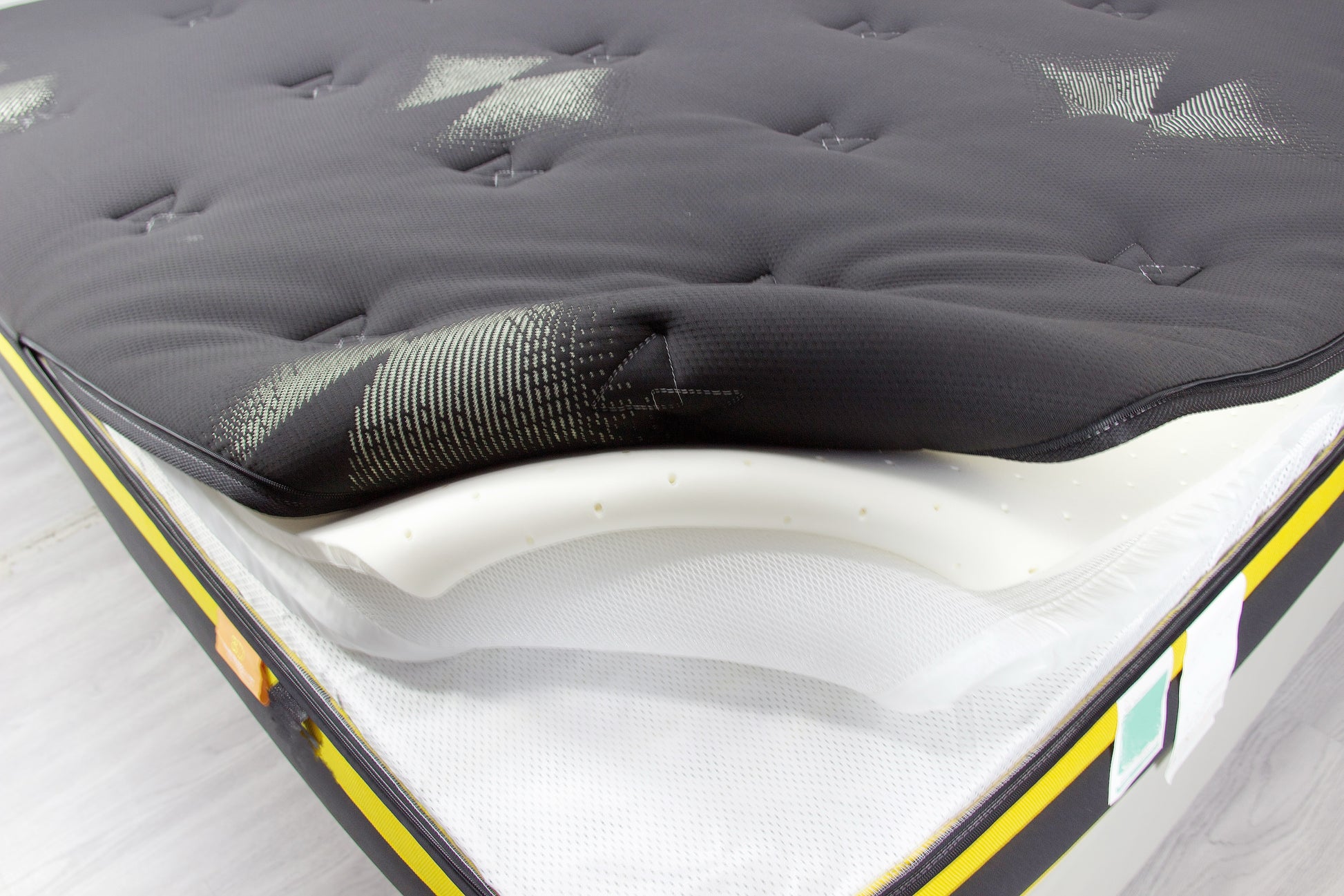 Black mattress encasement made from premium cotton with a zippered closure for full mattress protection.